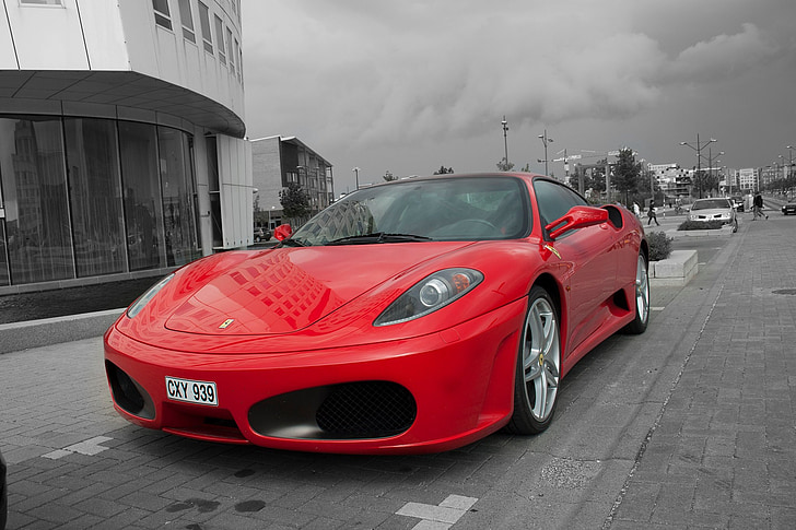 selective color photography of red Ferrari sports coupe