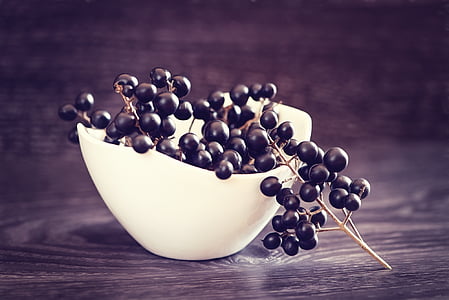 black berries on white bowl