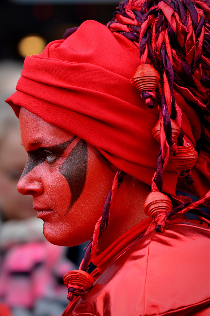 closeup photography of woman wearing red and black headdress
