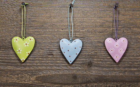three assorted-color heart pendant necklaces