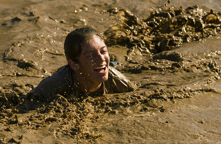 person submerged in mud