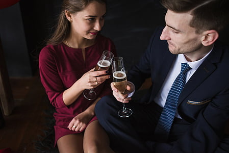 man and woman toasting champagne glass