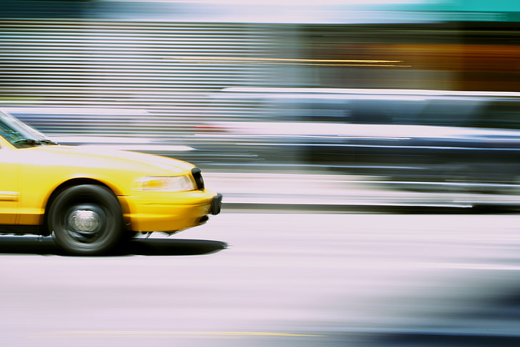 time lapse photography of yellow car