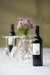 selective focus photograph of wine bottle and glass on white surface