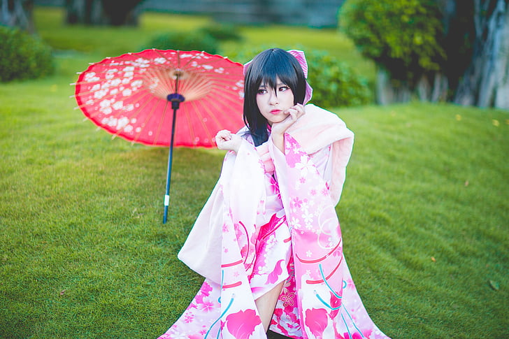 woman wears pink and white floral kimono