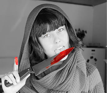 selective color photography of red blood stains on knife