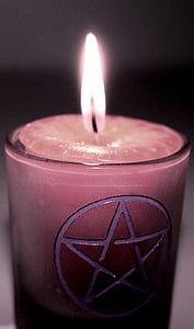 closeup photo of lighted pink votive candle