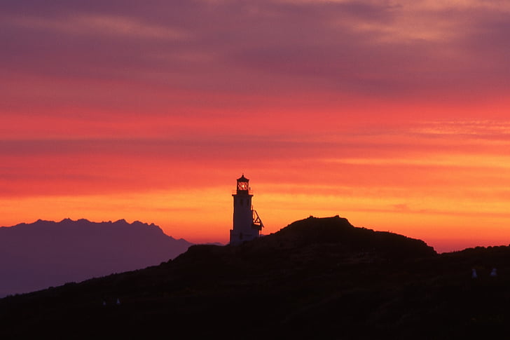 white lighthouse photo during sunset