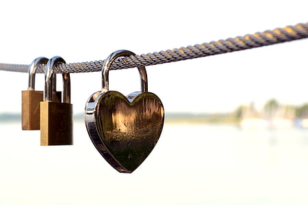 heart-shaped padlock locked on rope