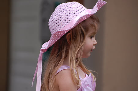 selective focus photography of girl wearing pink sunhat