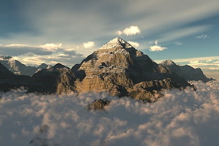 mountain over clouds during daytime