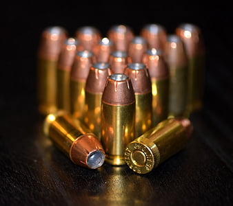 shallow focus photo of gold ammunition