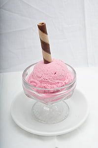 clear glass footed cup with pink ice cream