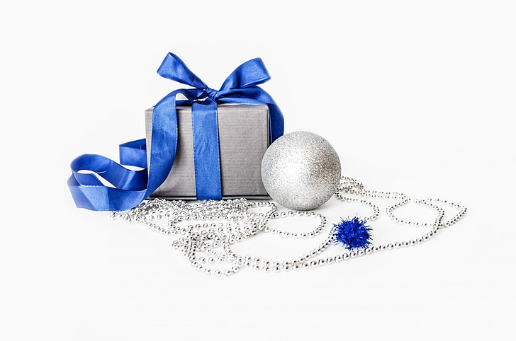 gray and blue gift box beside silver bauble