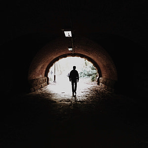 man walking in tunnel