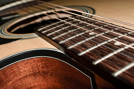 brown and black acoustic guitar