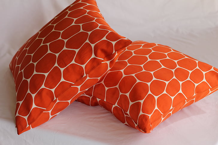 two orange-and-white throw pillows