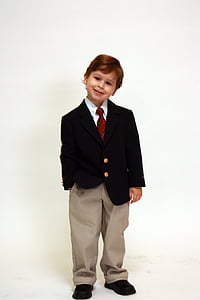 photo of boy wearing black suit jacket and gray dress pants