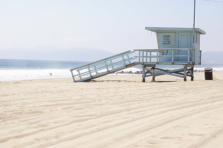 lifeguard tower near body of water during daytime
