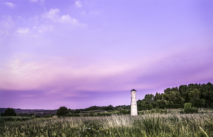 white lighthouse on green grass field