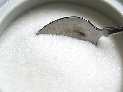 stainless steel spoon scooping sugar