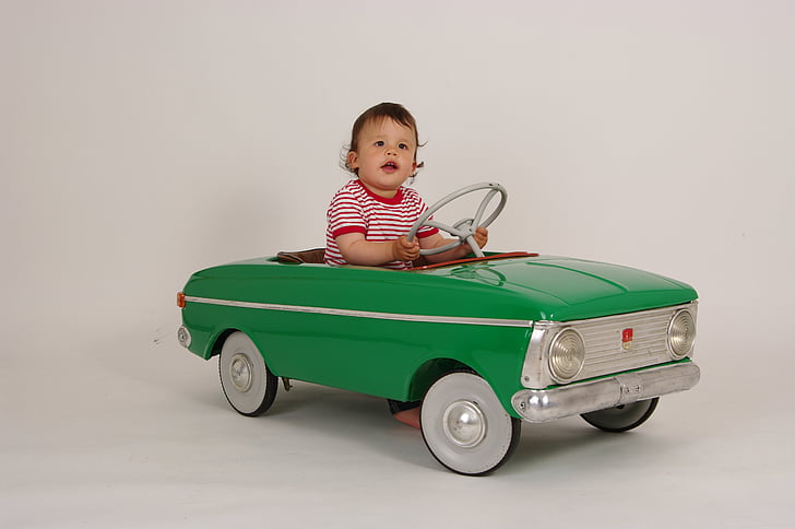 baby riding green ride-on toy car