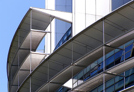 glass wall building under clear blue sky during daytime