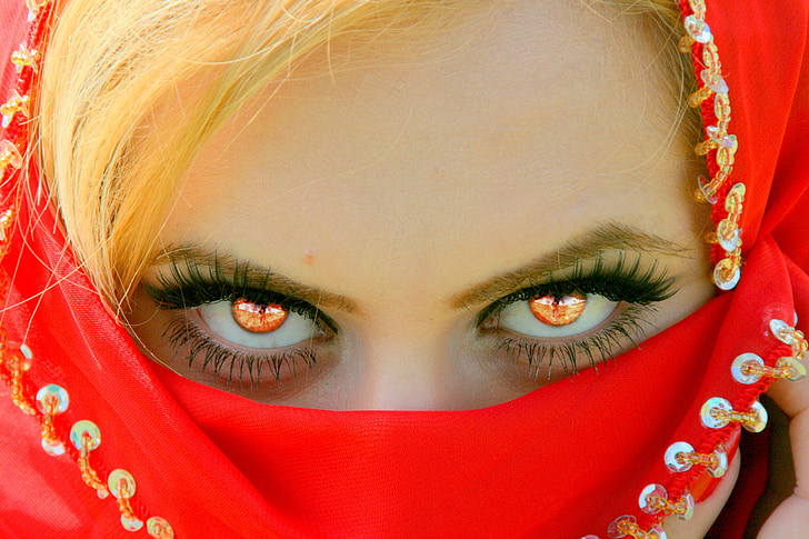 woman covering face with red textile