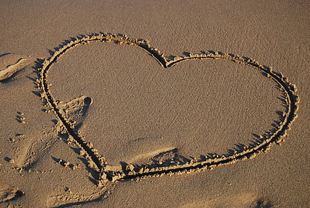 photo of white sand draw a heart