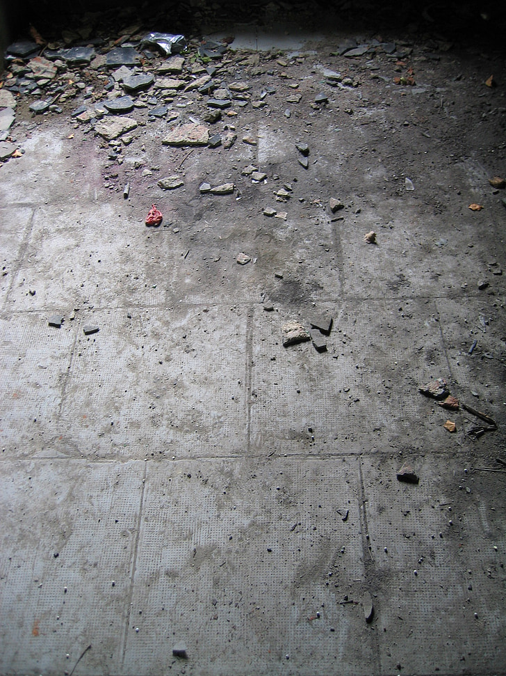 gray concrete floor with broken tiles