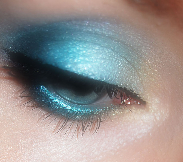 closeup photo of person's blue eyeshadow