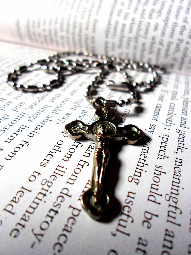 rosary on open book