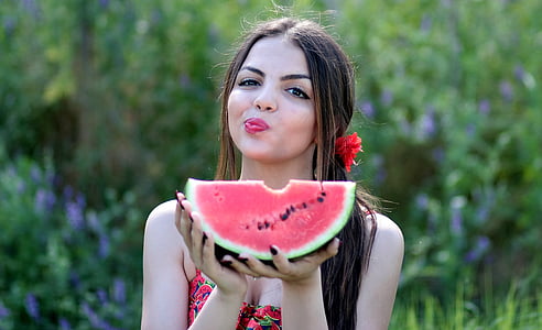 woman holding watermelon at daytime