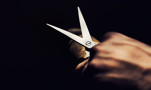 person holding scissor