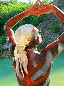 statue of man near body of water