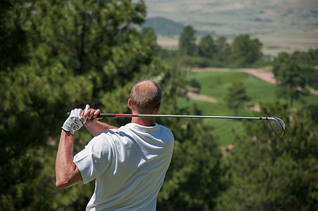shallow focus photography man playing golf
