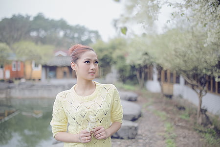 selective focus photo of woman wearing yellow top