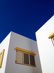 white wall paint house during daytime