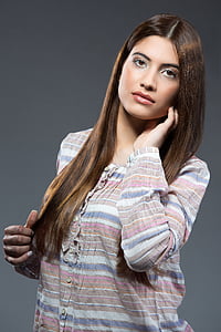 woman wearing brown, pink, and blue striped long-sleeved shirt