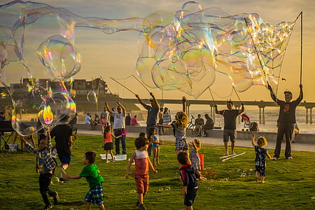 group of people playing with bubbles