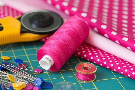 pink thread with needles