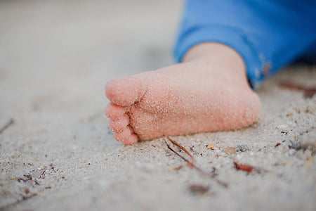 selective focus photography of child foot
