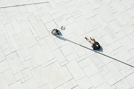 two persons on white concrete floor