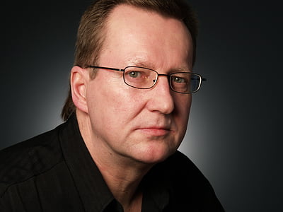 man in black shirt wearing eyeglasses with silver frames
