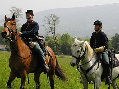 two men riding horse