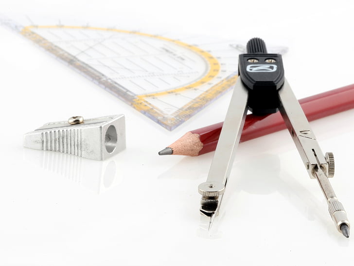 red pencil beside grey and black graphing compass and grey sharpener