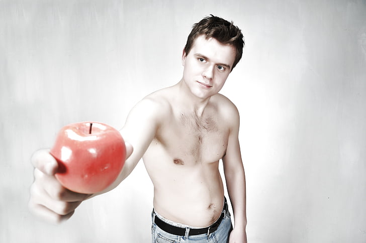 man holding red apple using his right hand