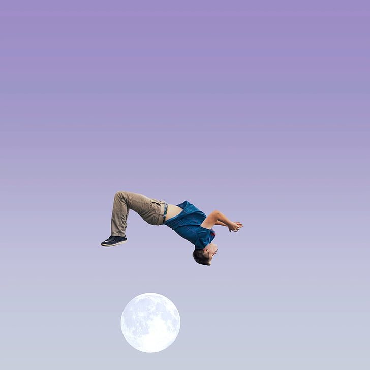 man in blue shirt and brown pants above moon