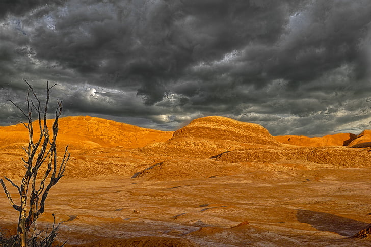 panoramic photography of desert above dark clouds