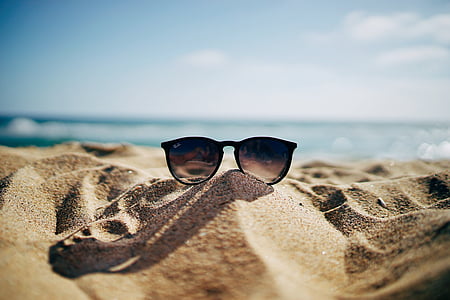 photo of black Ray-Ban oversize sunglasses on brown sand